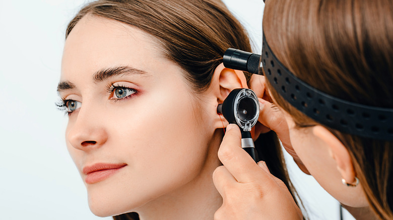 doctor looking into patient's ear