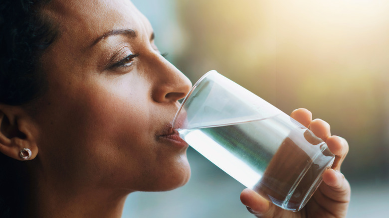 A woman drinking a glass of water