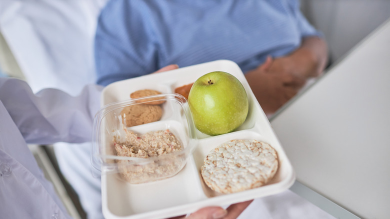 Caregiver bringing lunch to sick person