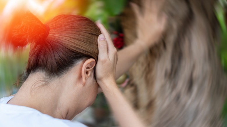 Woman feeling dizzy while outdoors 