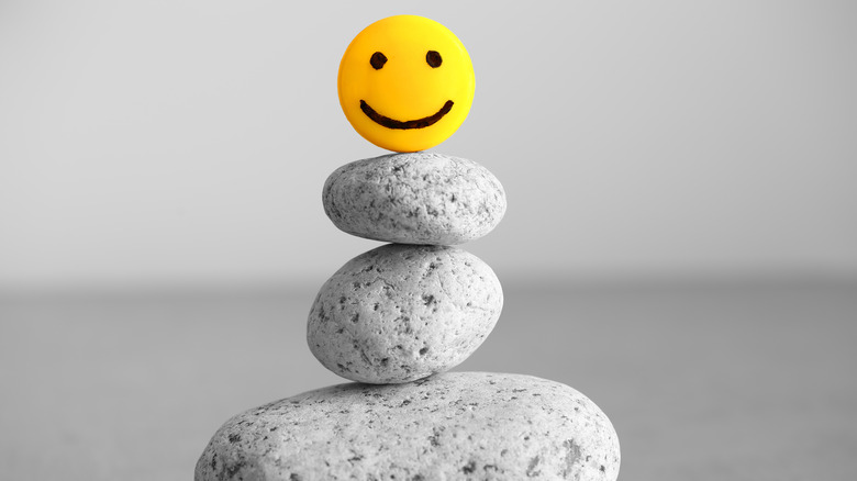 smile balancing on several stones