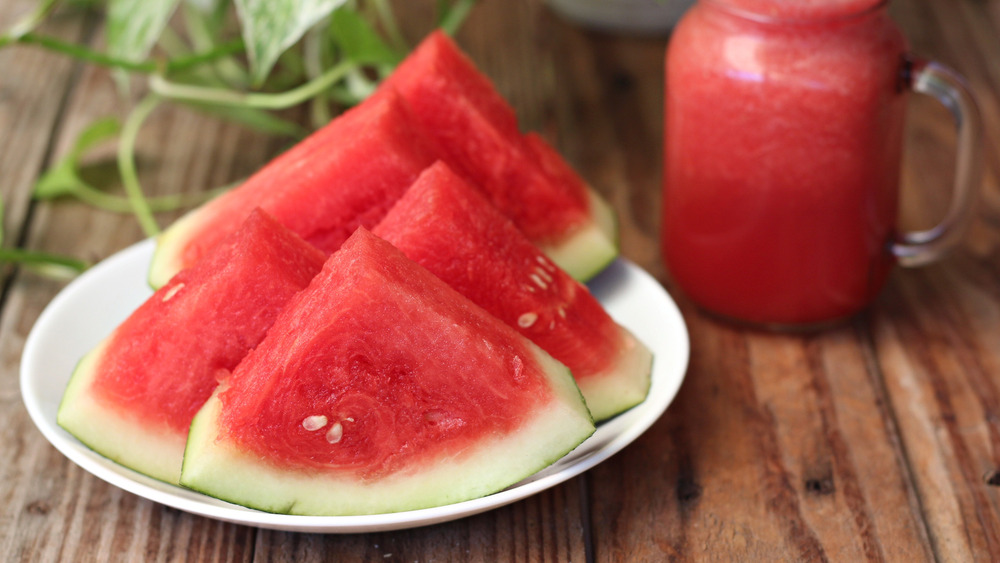 A plate of watermelon sits on a table