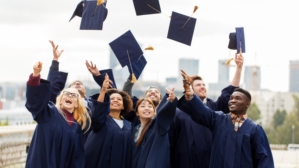 Graduates throw their mortar boards