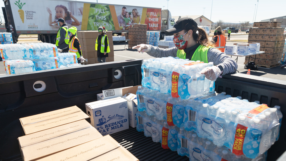 Volunteer distributes bottled water