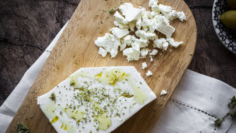 Feta cheese on wooden cutting board