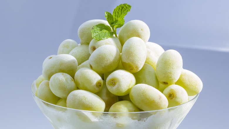 frozen green grapes in martini glass