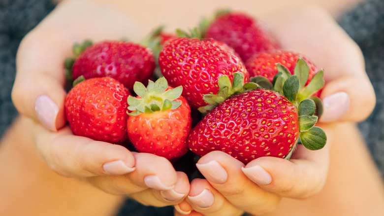 two handfuls of strawberries