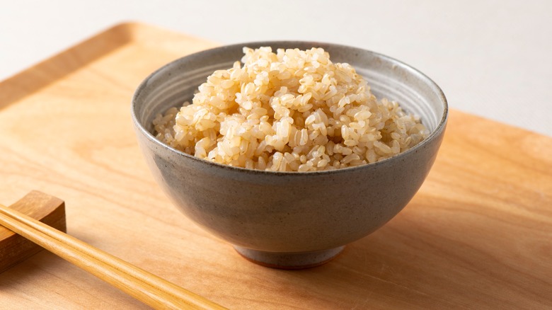 brown rice in bowl with chopsticks 