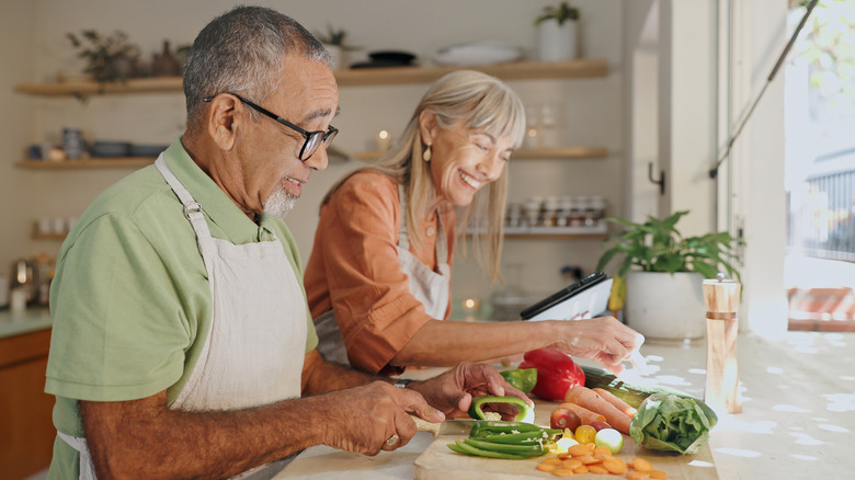 older couple making a vegetable meal together