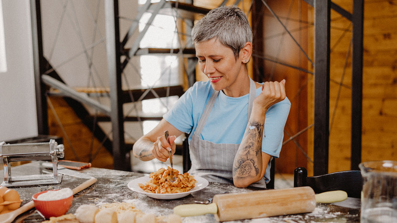 woman eating fresh pasta