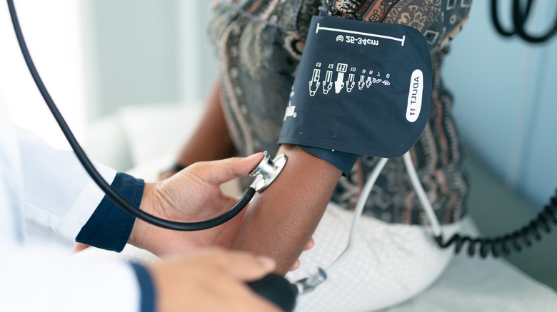 Doctor measuring patient blood pressure