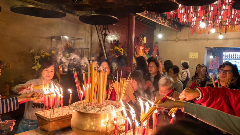 women around burning incense