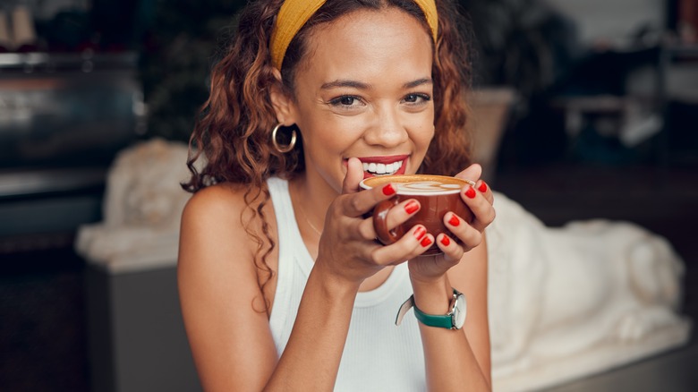 smiling woman drinking coffee