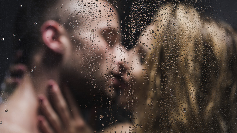 woman and man embracing and kissing in shower