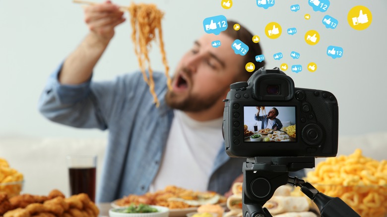 video recording man eating many dishes