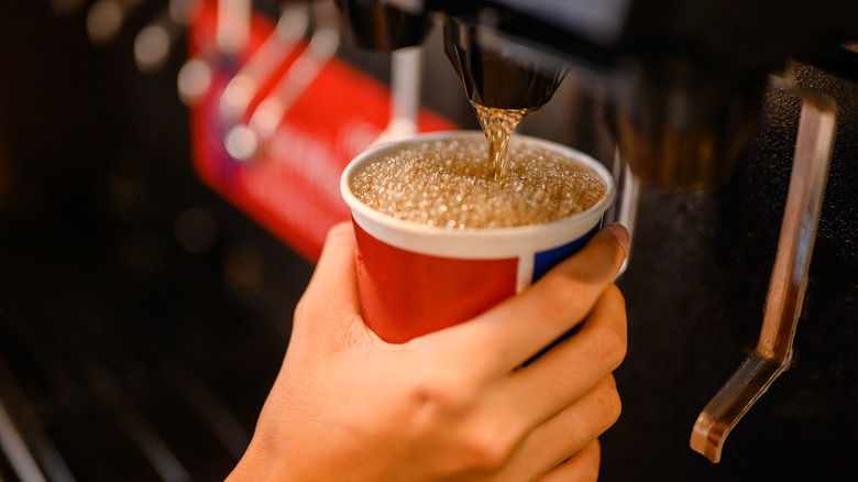 Person getting soda from fountain