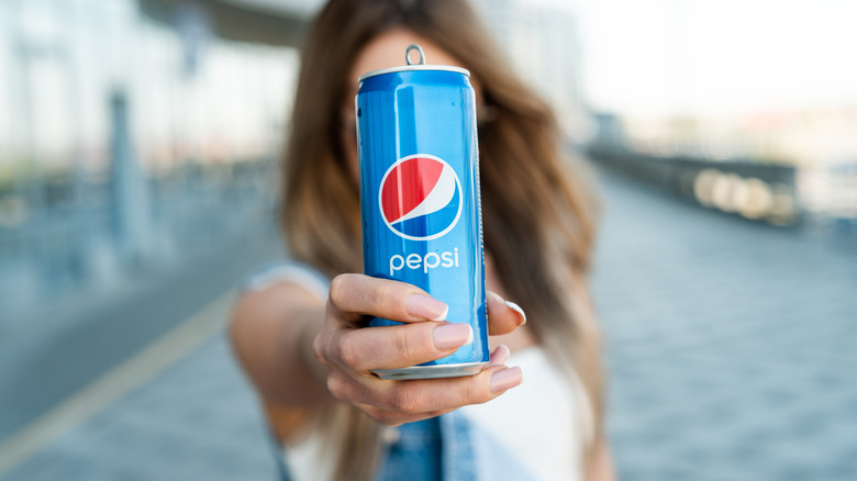 Women holding can of Pepsi