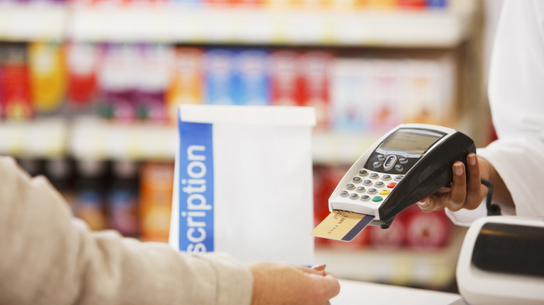 person paying for medication with credit card