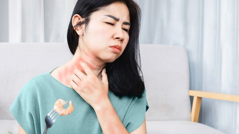 woman feeling a rash on her neck