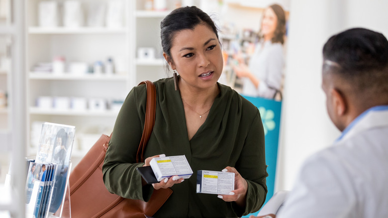 woman talking to pharmacist about medication