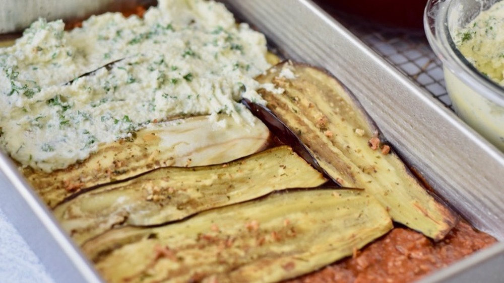 eggplant slices with ricotta filling on top of meat sauce