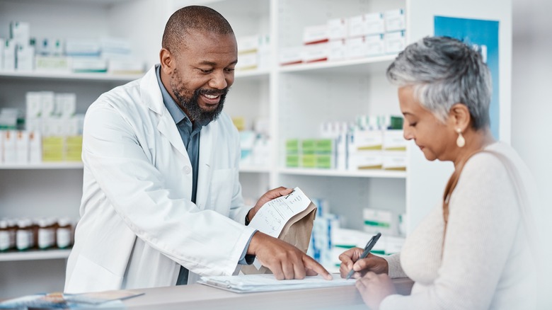 Woman being counseled by pharmacist