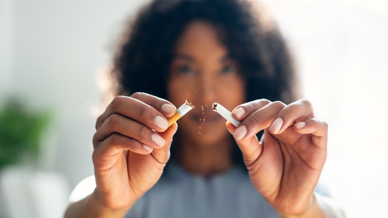 woman breaking a cigarette