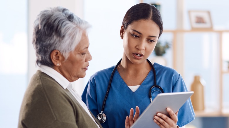 doctor talking to older female patient