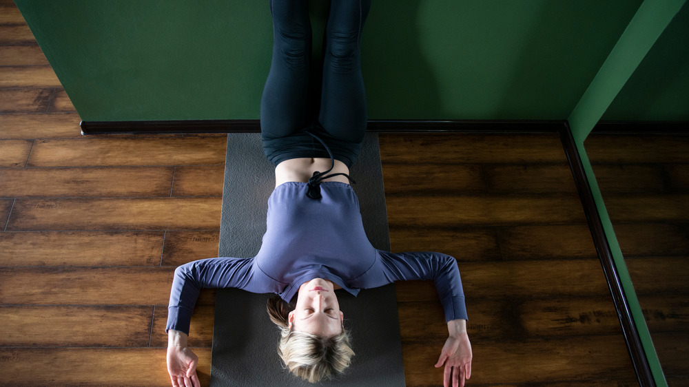 Woman doing yoga on floor