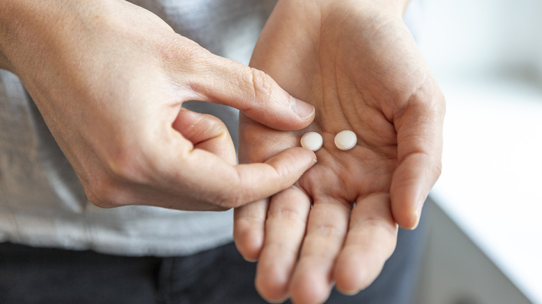 pills in a person's hand