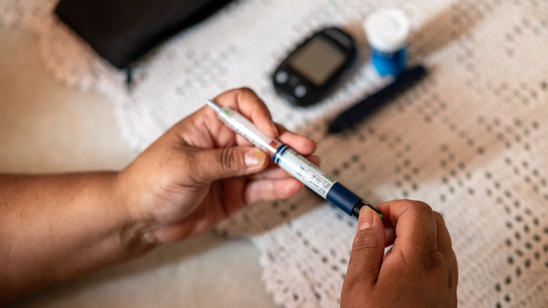 woman preparing her insulin injection