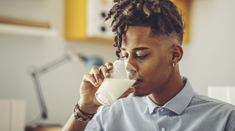 Person drinking glass of milk