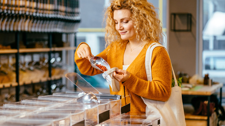 smiling woman shopping for dried goji berries