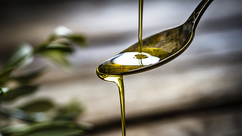 oil pouring onto a spoon