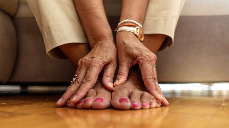 Woman sitting and touching her toes