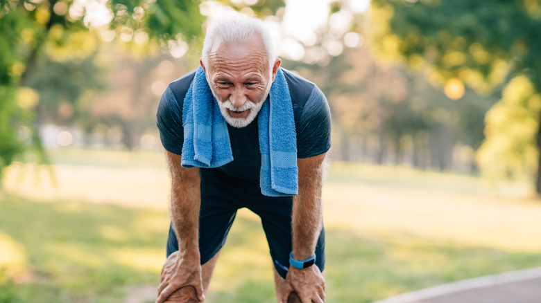 Mature man bending over in heat