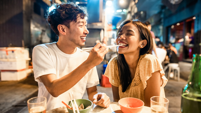 Asian couple eating together