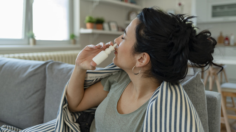 Woman using nasal spray