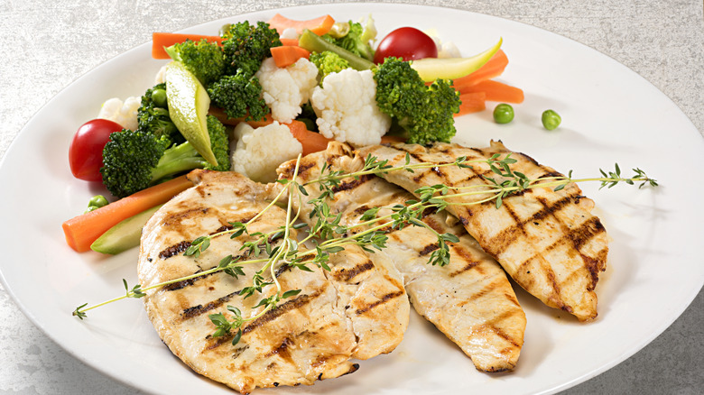 A plate of chicken breast with vegetables