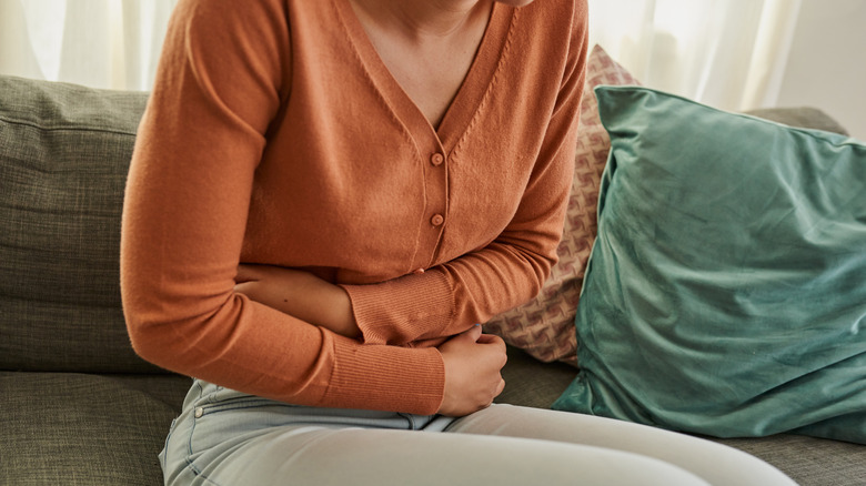 woman holding her lower stomach