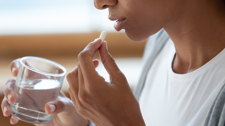 woman taking pill