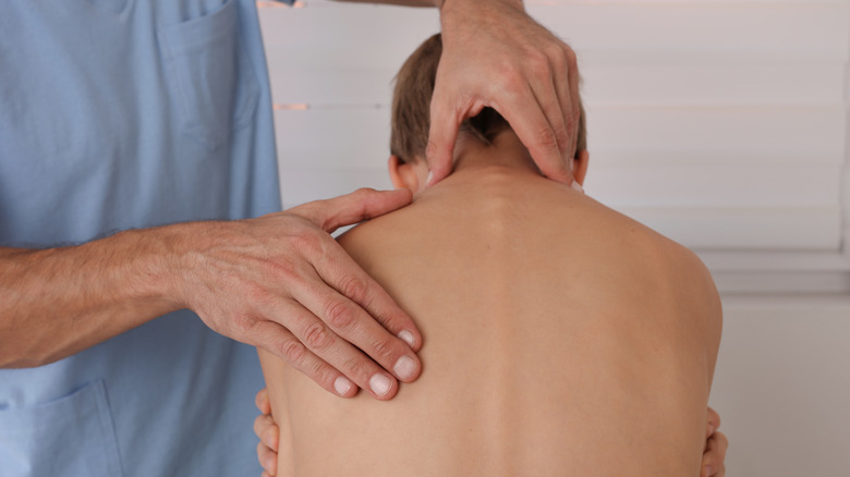 Young patient is checked for scoliosis