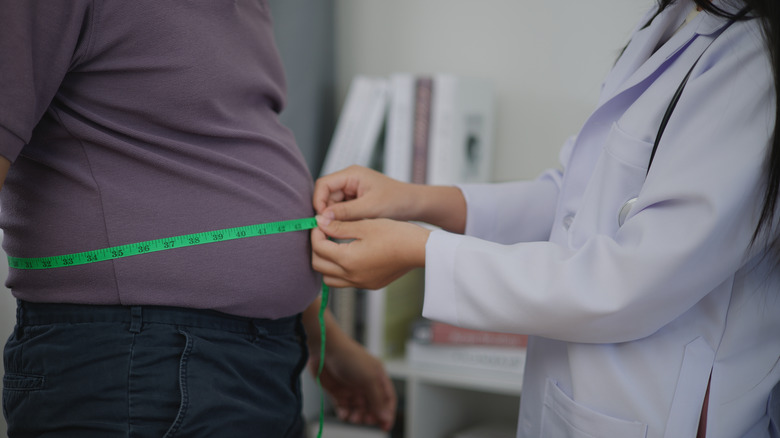 doctor checking male patient for metabolic syndrome