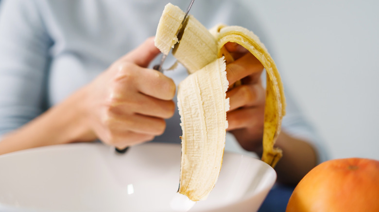 Hand slicing banana