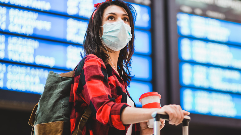 Woman wearing face mask at the airport 