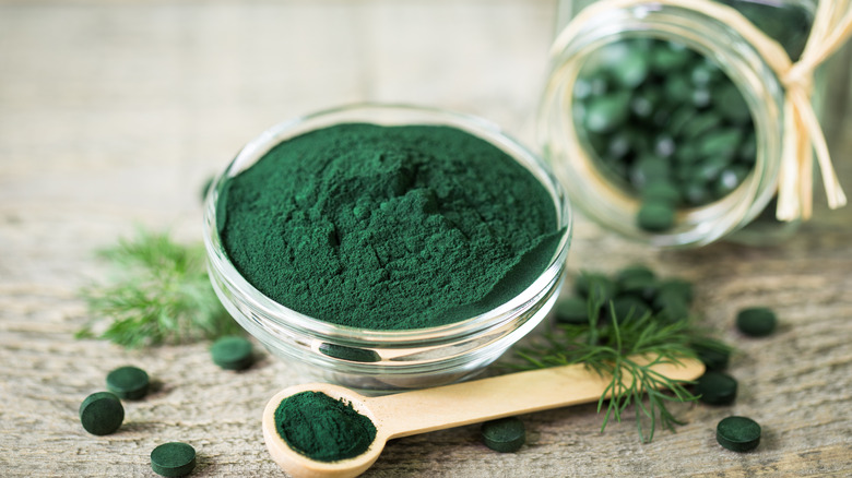 spirulina powder and tablets on a table 