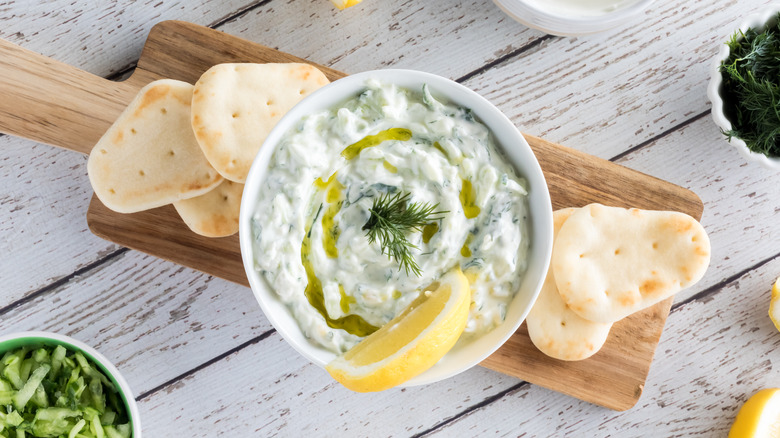 a bowl of tzatziki sauce and the ingredients