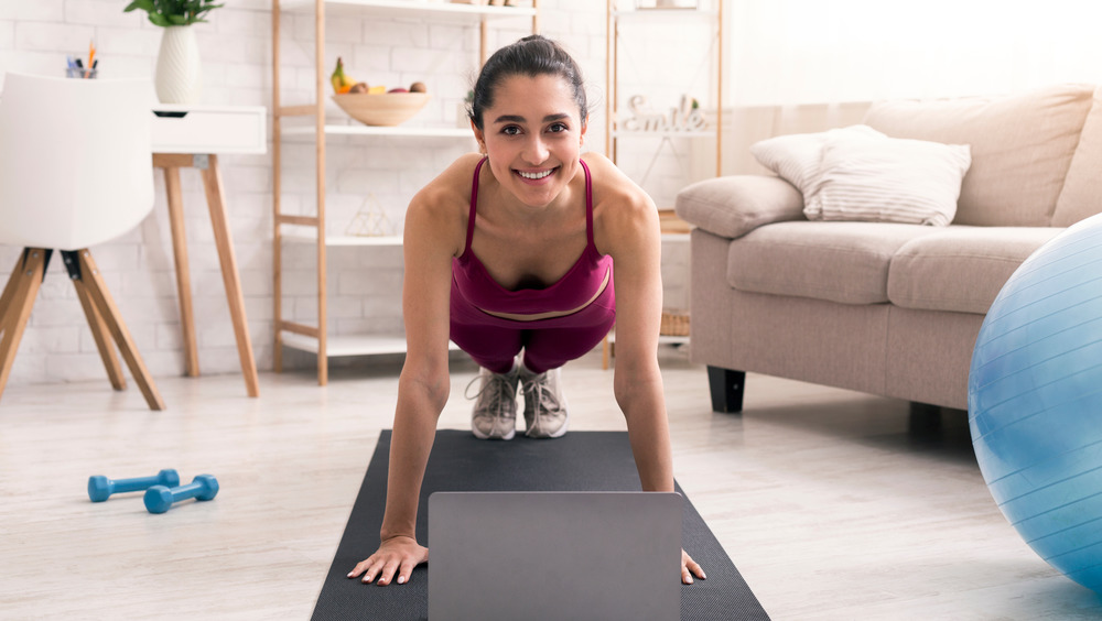 Smiling woman in plank pose