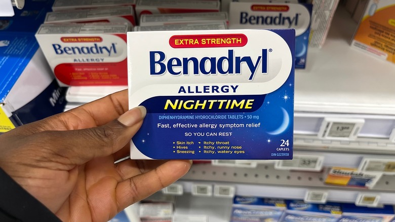 Hand holding pack of Benadryl