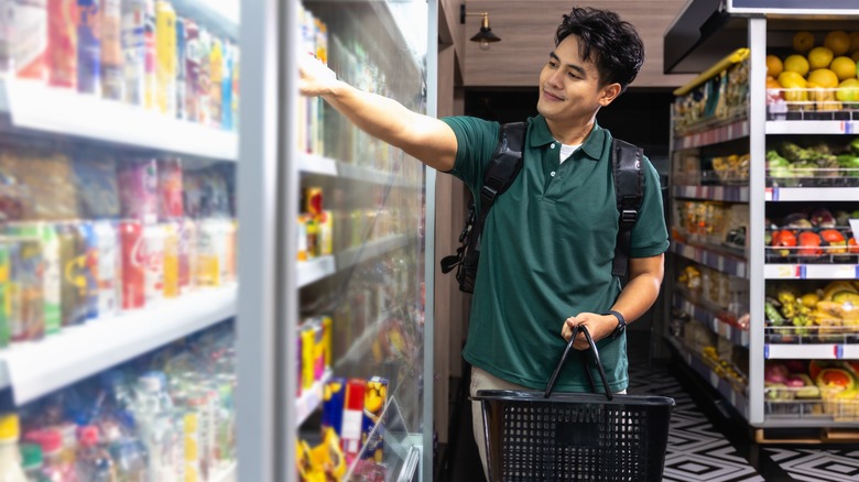 Smiling man selecting beverage